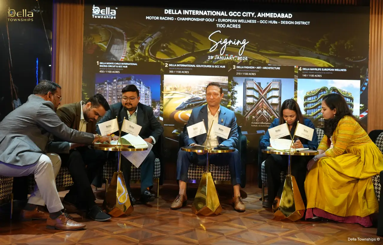 Leadership signing official documents at Della Townships Ahmedabad event
