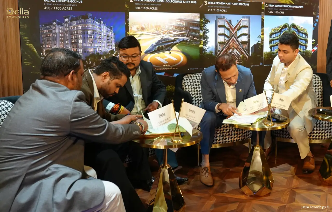 Executive signing documents during Della Townships Ahmedabad launch event