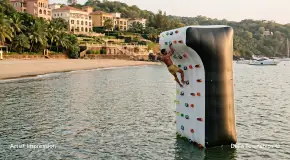 Floating water climbing wall activity at Della Townships Lake Como Dapoli