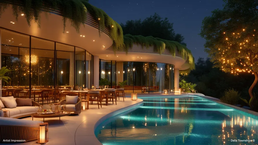 Luxury villa at night with an illuminated infinity pool, outdoor lounge seating and rooftop greenery at Della Townships